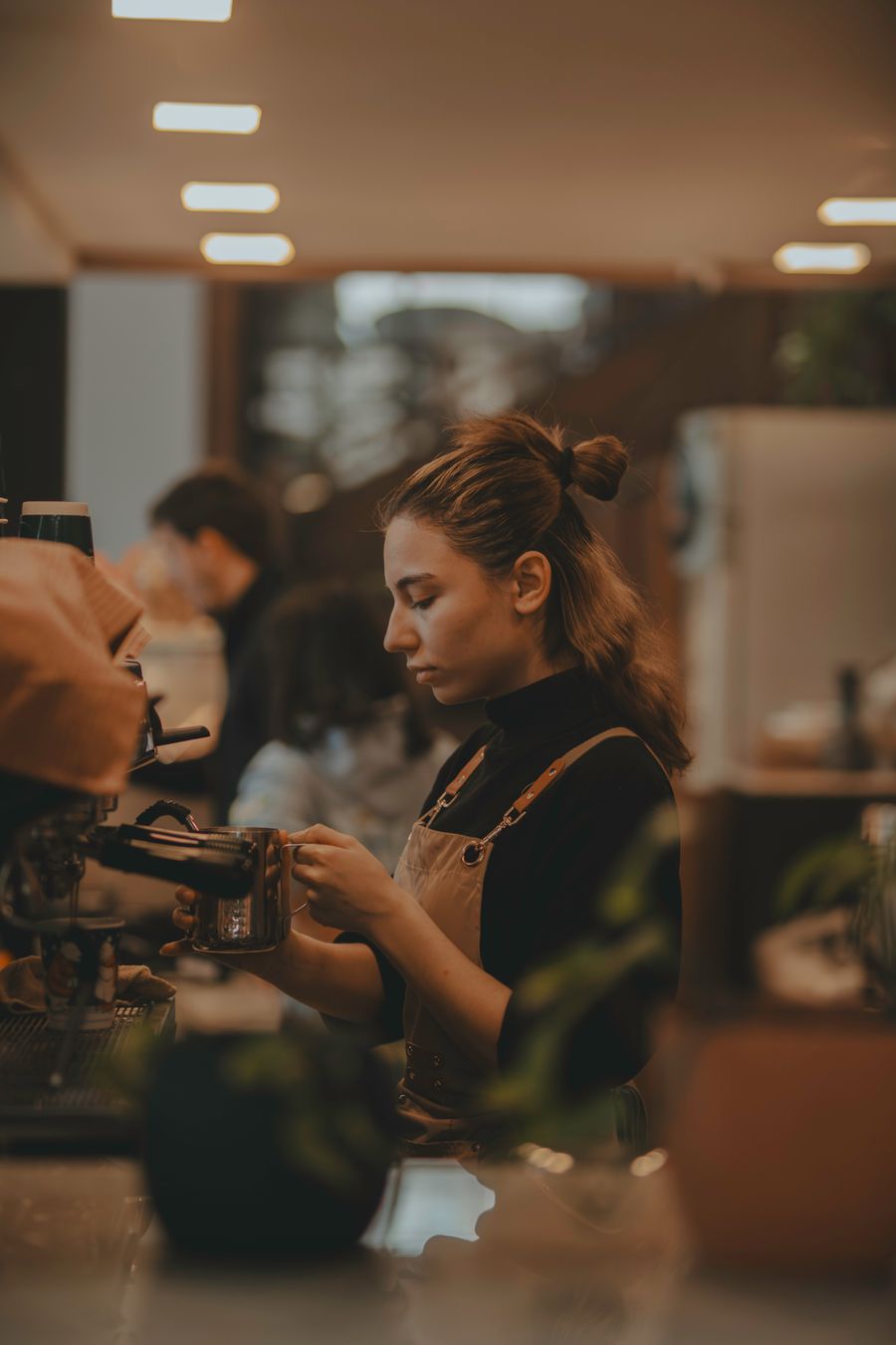 A barista preparing coffee in a café, photographed by Rahib Hamidov