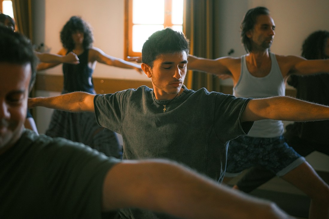 People practising yoga together in a studio, photographed by Christian Harb